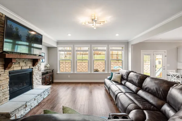 a living room with furniture fireplace and flat screen tv