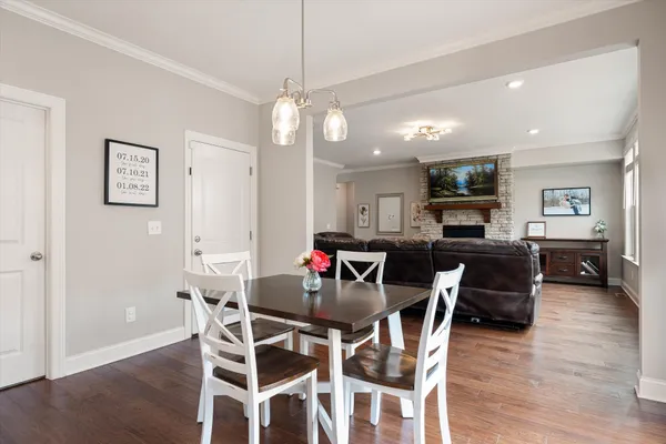 a view of a dining room with furniture wooden floor and chandelier