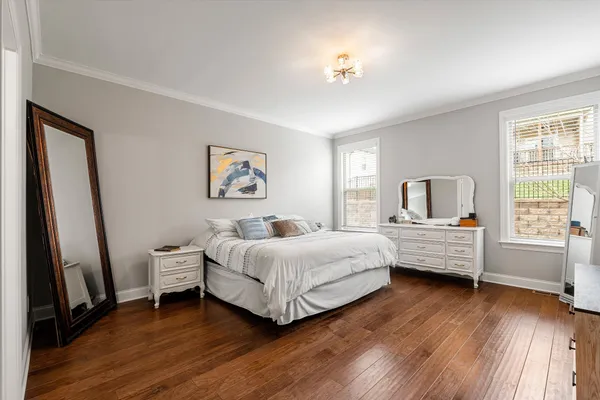 a bedroom with a bed and a chandelier
