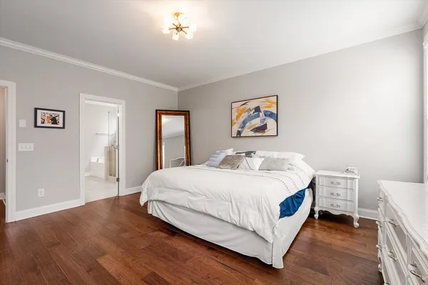 a bedroom with furniture and wooden floor