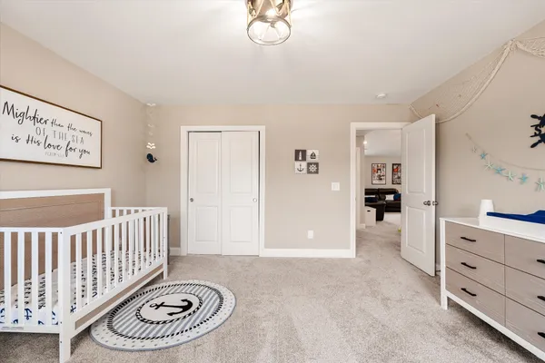 a bedroom with furniture and a large window