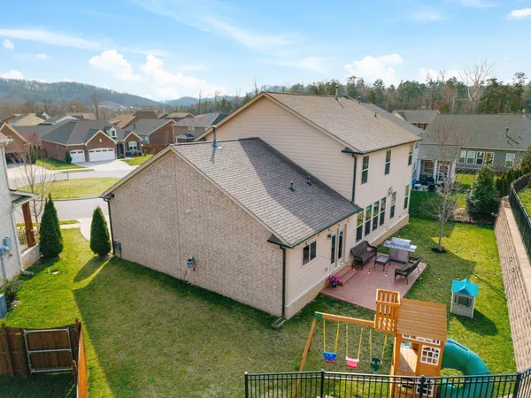 an aerial view of residential houses with outdoor space and ocean view