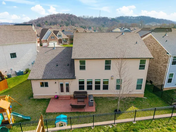 an aerial view of residential houses with outdoor space and parking