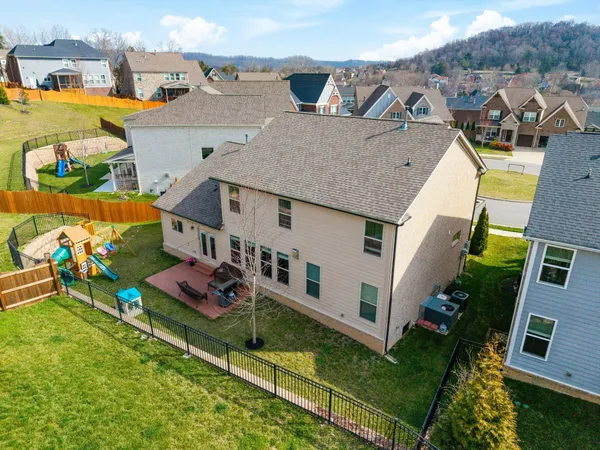 an aerial view of a house with outdoor space and lake view