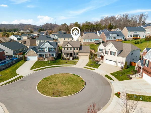 an aerial view of residential houses with outdoor space and swimming pool