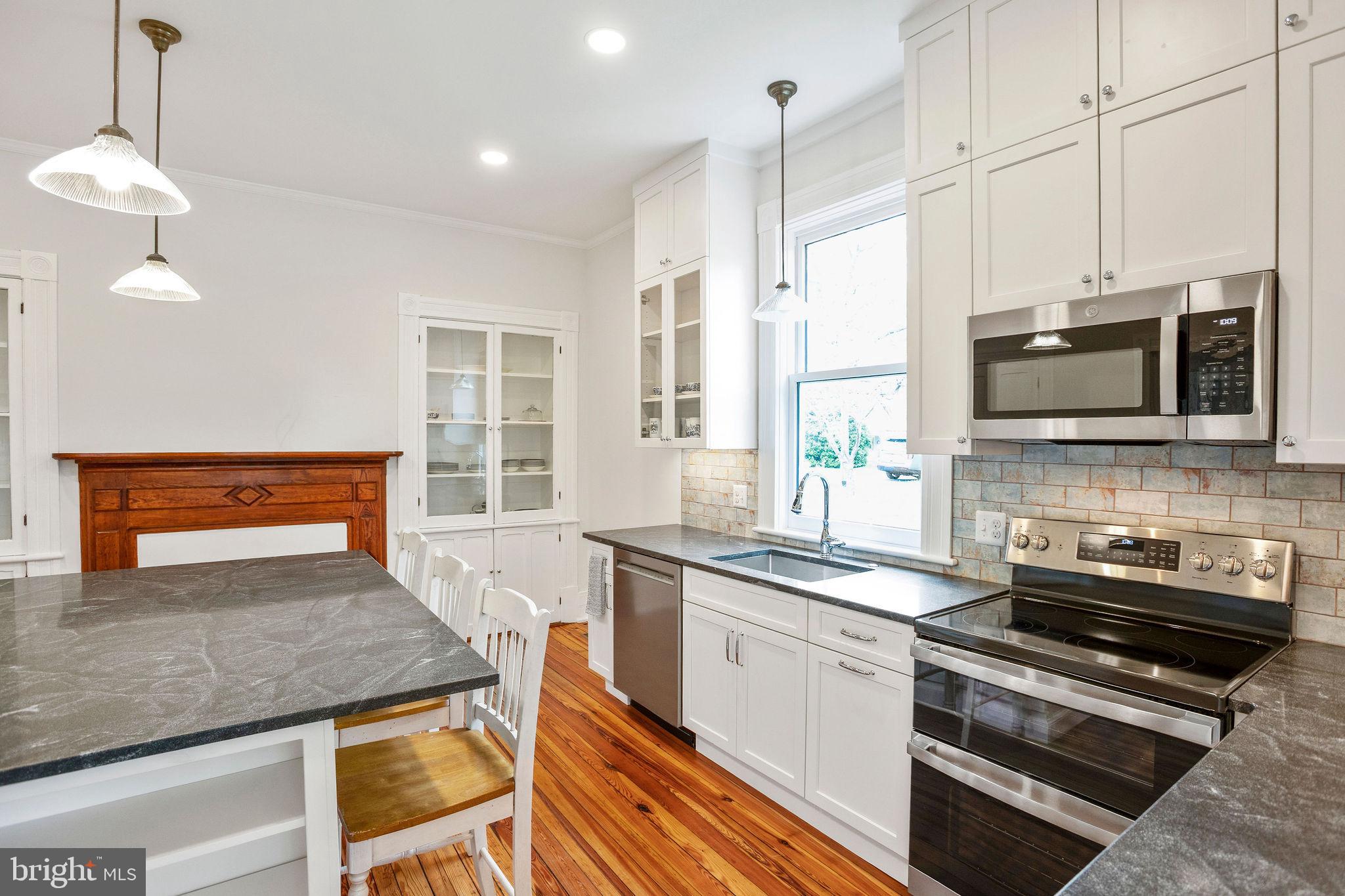 558 Gay Street Washington, VA 22747 - Photo 20 of 52 a kitchen with stainless steel appliances granite countertop a stove a sink and a microwave
