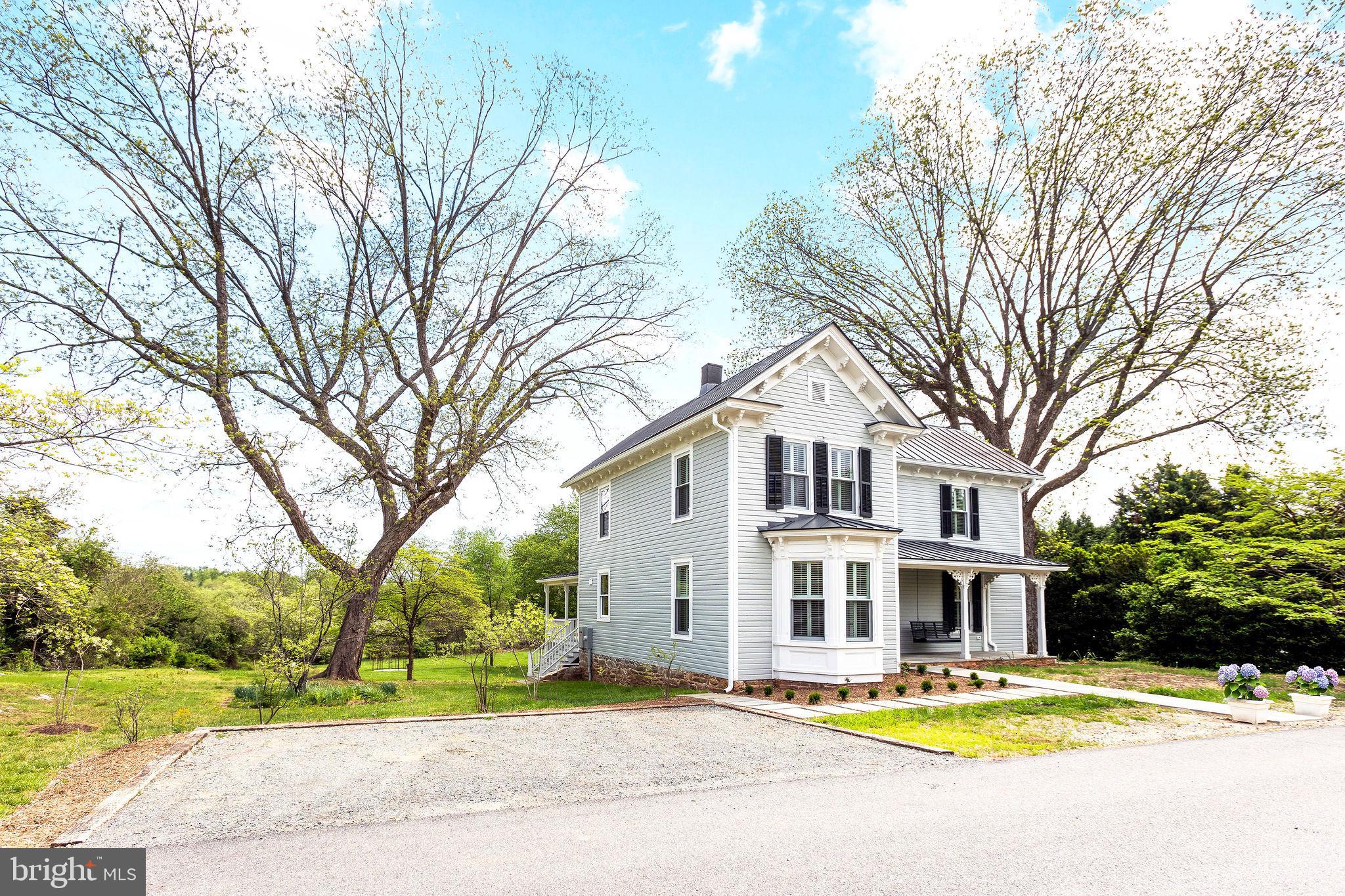 558 Gay Street Washington, VA 22747 - Photo 2 of 52 a view of a white house with a large tree and yard