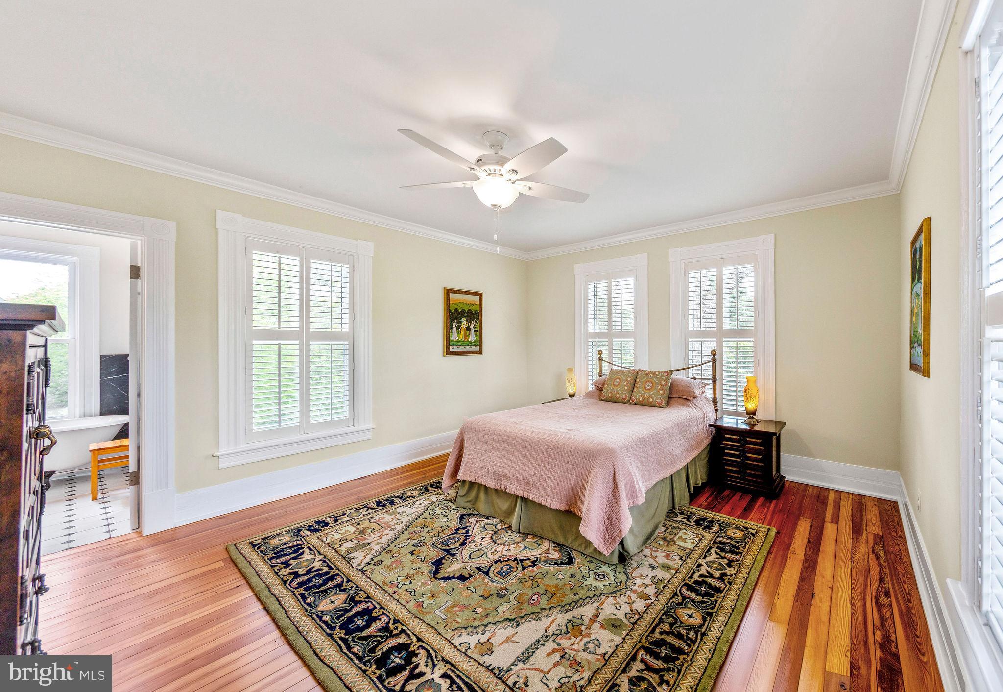 558 Gay Street Washington, VA 22747 - Photo 27 of 52 a spacious bedroom with a bed and wooden floor
