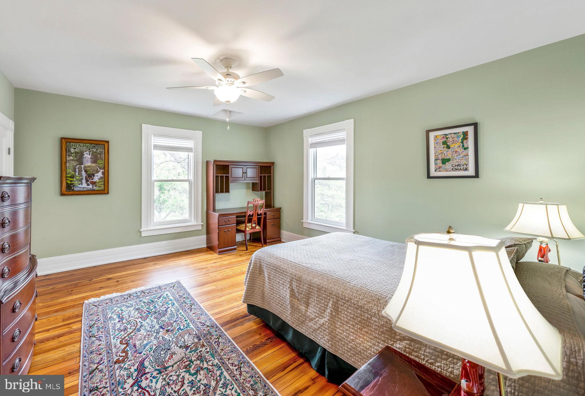 558 Gay Street Washington, VA 22747 - Photo 32 of 52 a spacious bedroom with a bed and wooden floor