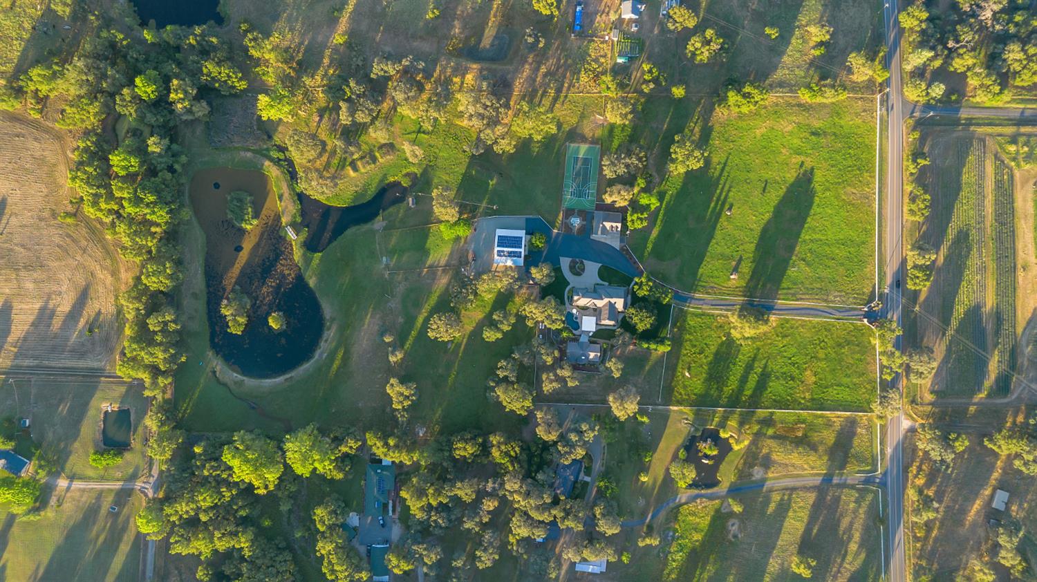 2905 Virginiatown Road Lincoln, CA 95648 - Photo 77 of 86 Expansive acreage featuring a private pond with central islands, a tennis court, multiple structures, and extensive green space