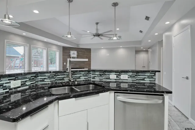 a kitchen with kitchen island a counter space a sink and appliances