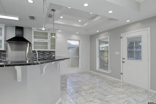 a kitchen with stainless steel appliances granite countertop a sink and a refrigerator