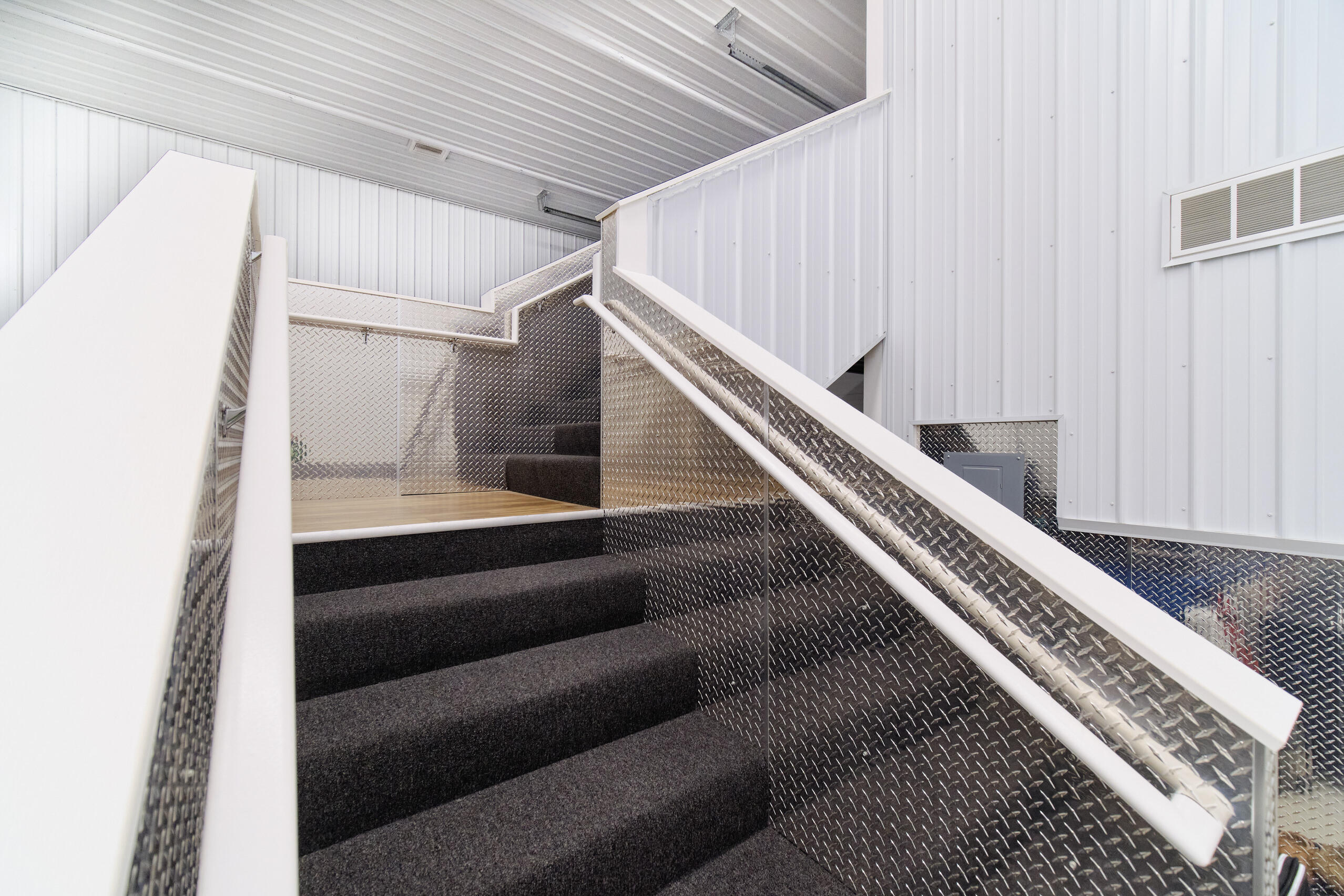5859 Potter Road Onekama, MI 49675 - Photo 51 of 85 Wide stairs to upper level of garage