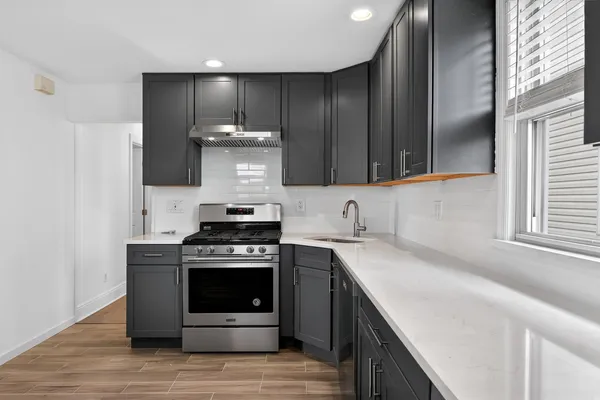 a kitchen with a stove and a sink