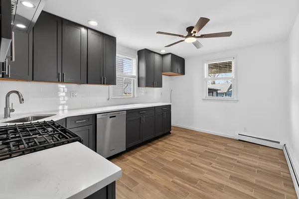 a kitchen with a sink a stove and cabinets