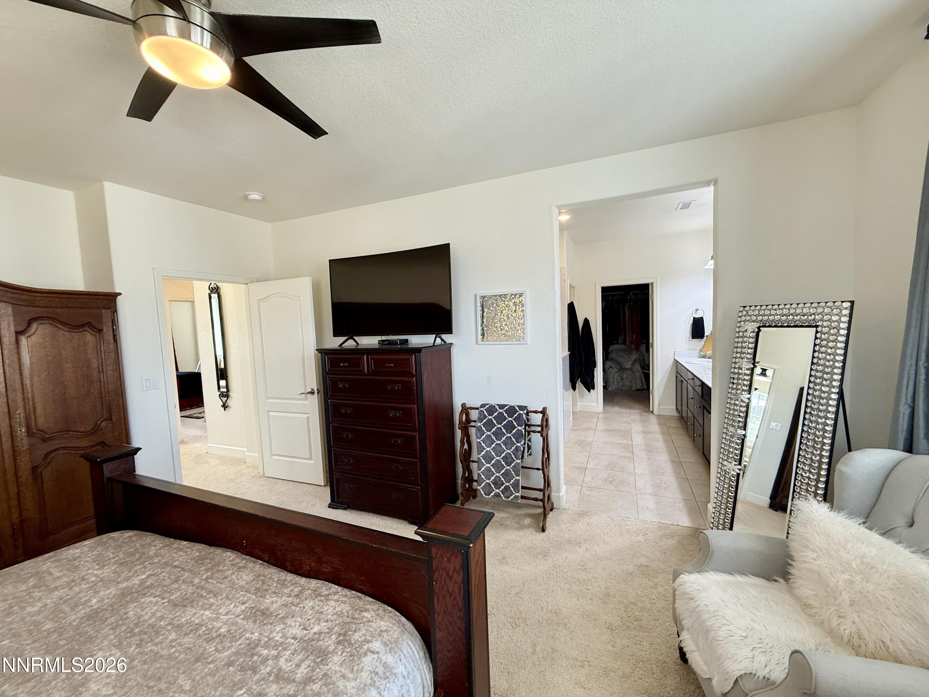 9766 Pachuca Drive Reno, NV 89521 - Photo 25 of 59 a bedroom with furniture and a flat screen tv