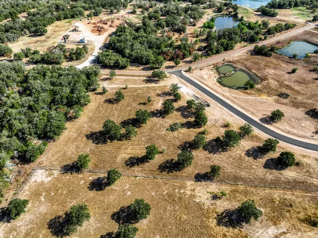 a view of a yard with wooden fence