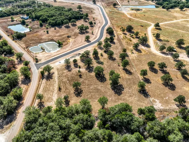 an aerial view of a house with a yard