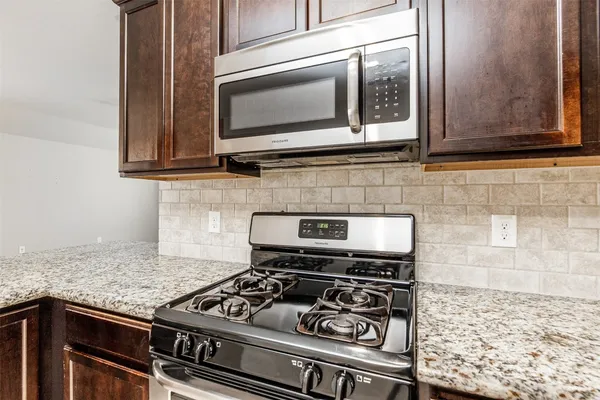 a kitchen with a stove and a microwave