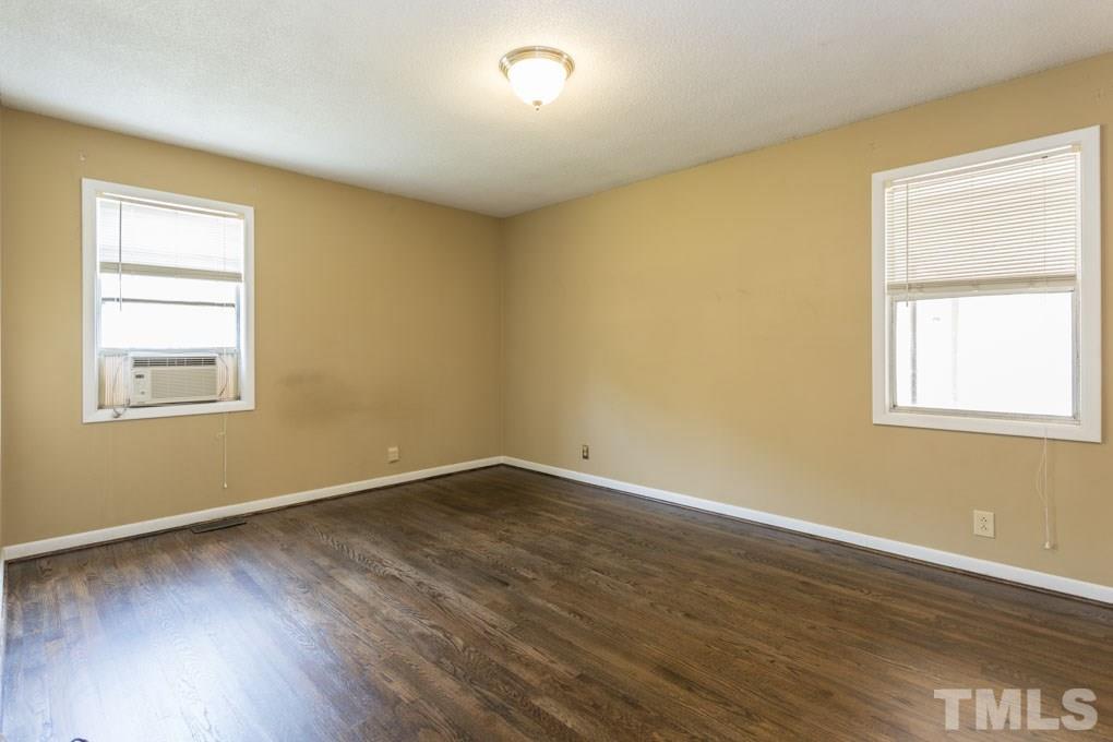 3540 Brentwood Road Raleigh, NC 27604 - Photo 22 of 29 a view of an empty room with wooden floor and a window