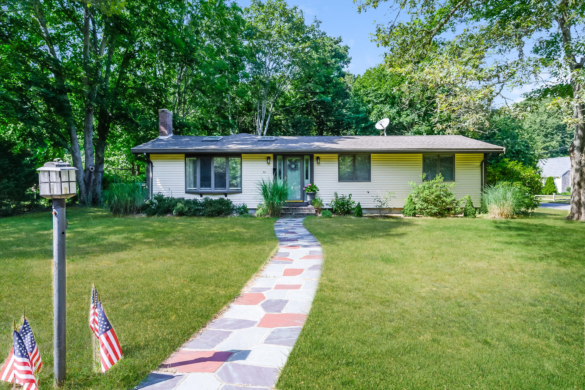 54 Pine Tree Drive Centerville, MA 02632 - Photo 1 of 16 a front view of house with yard and green space