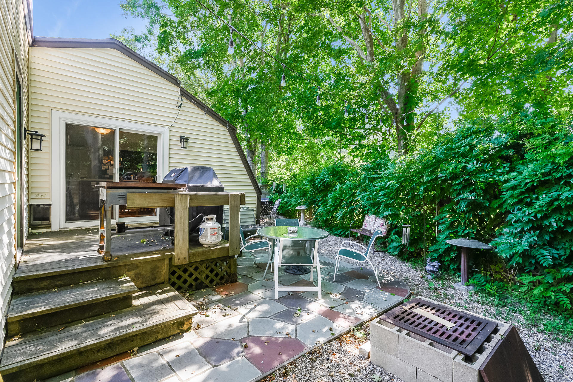 54 Pine Tree Drive Centerville, MA 02632 - Photo 15 of 16 a view of a patio with table and chairs with wooden floor and fence