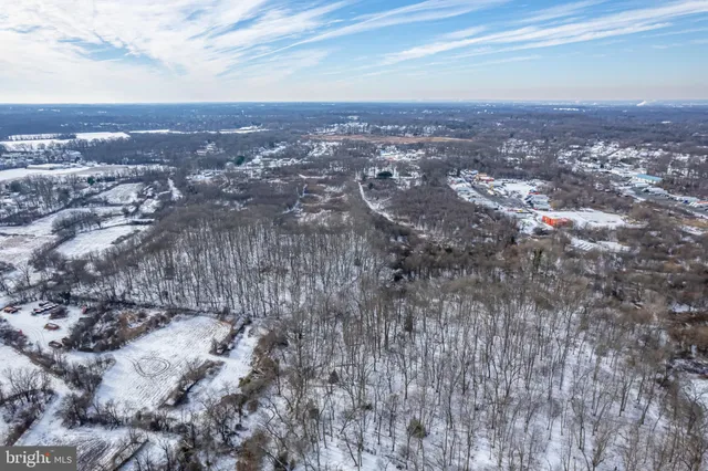 an aerial view of residential house and car parked