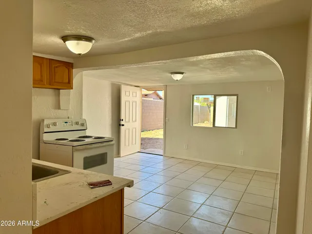 a kitchen with a stove a sink and a refrigerator
