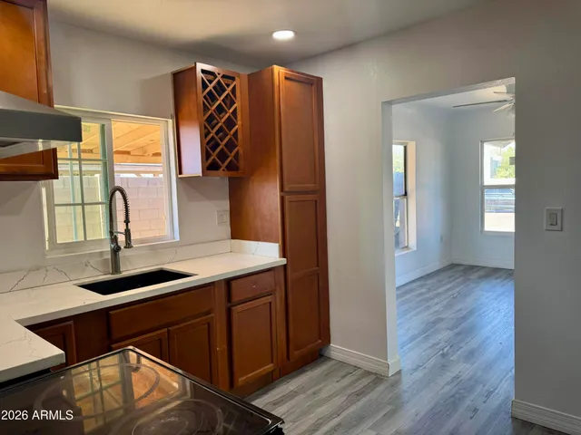 a kitchen with a sink cabinets and wooden floor