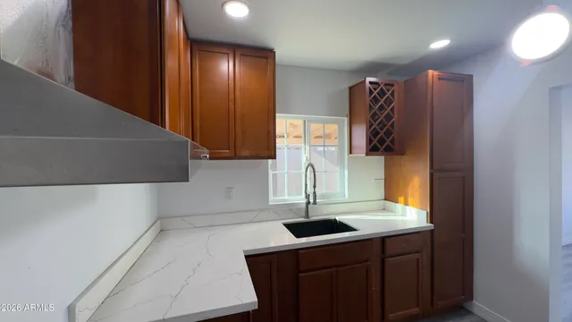 a kitchen with a refrigerator and a stove