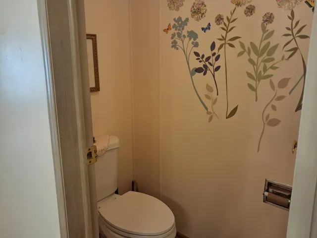 a bathroom with a toilet and shower