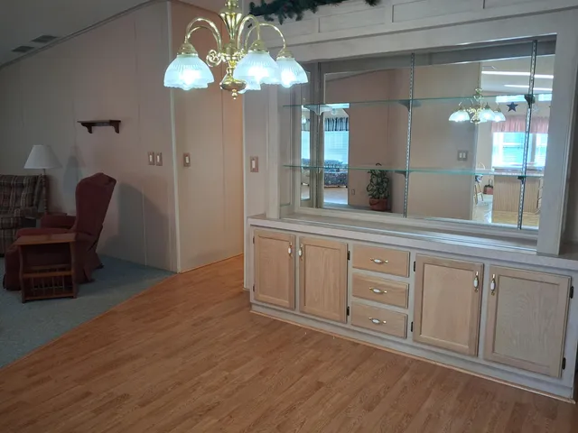 a spacious bathroom with a granite countertop sink a mirror and a vanity