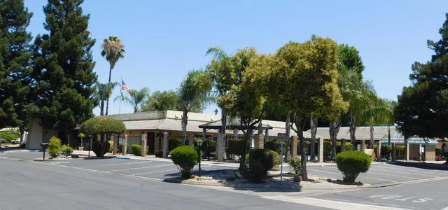a front view of a building with tree s