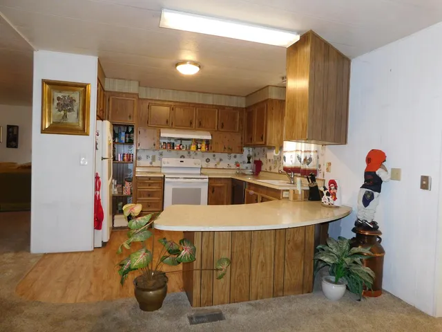a kitchen with a sink a stove and chairs