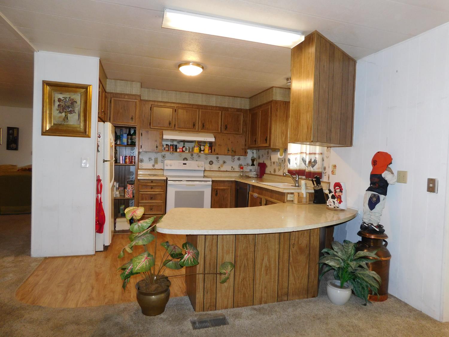 43 Rio Vista Drive Lodi, CA 95240 - Photo 6 of 27 a kitchen with a sink a stove and chairs