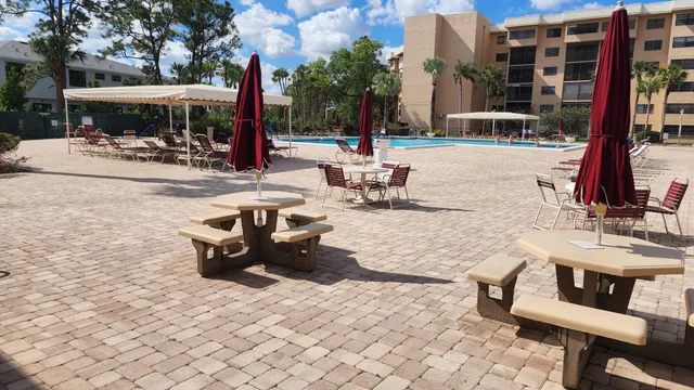 a view of a patio with a table and chairs and potted plants
