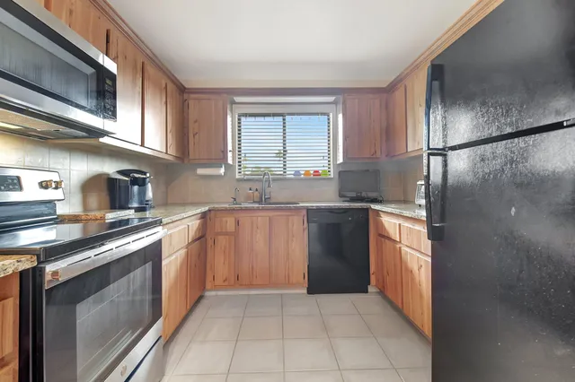 a kitchen with a sink stove and refrigerator