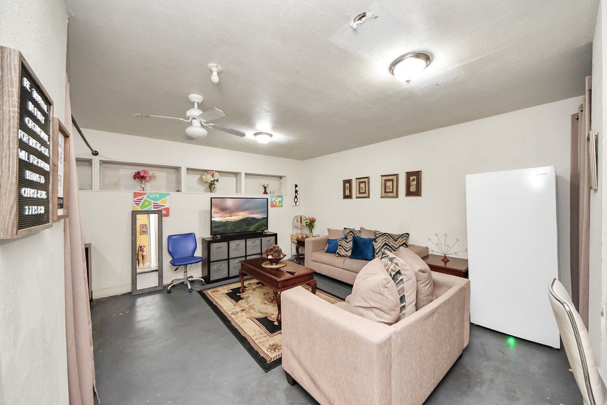 4155 Amir Street Houston, TX 77072 - Photo 24 of 43 a living room with furniture and a flat screen tv