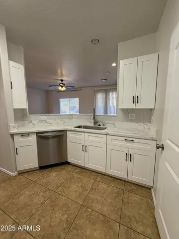 a kitchen with a stove top oven sink and cabinets