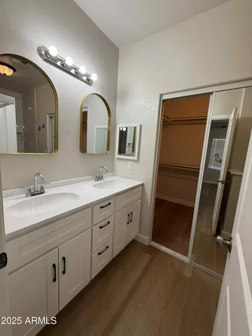 a spacious bathroom with a double vanity sink and a mirror