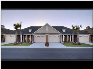4243 Jade Loop, Unit D23 Destin, FL 32541 - Photo 1 of 1 a front view of a house with garden