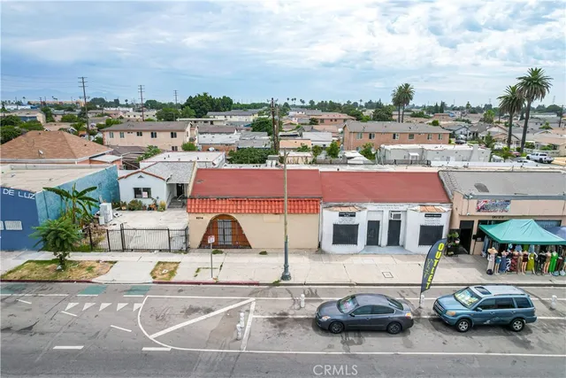 a aerial view of a house with a garden and car parked