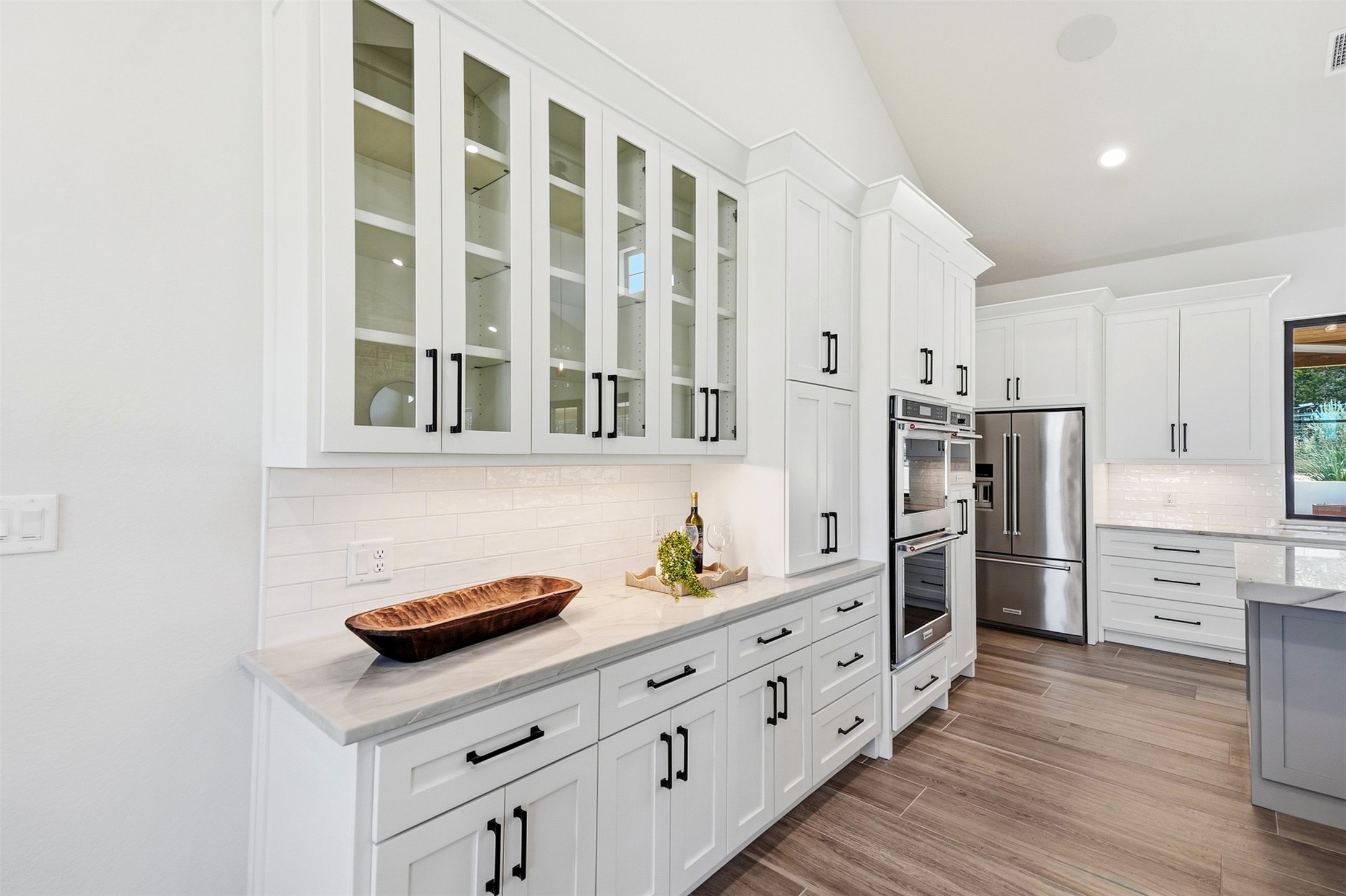 27619 Sunset Loop Garden Ridge, TX 78266 - Photo 8 of 39 Gleaming stone countertops and custom white cabinetry elevate this culinary space.
