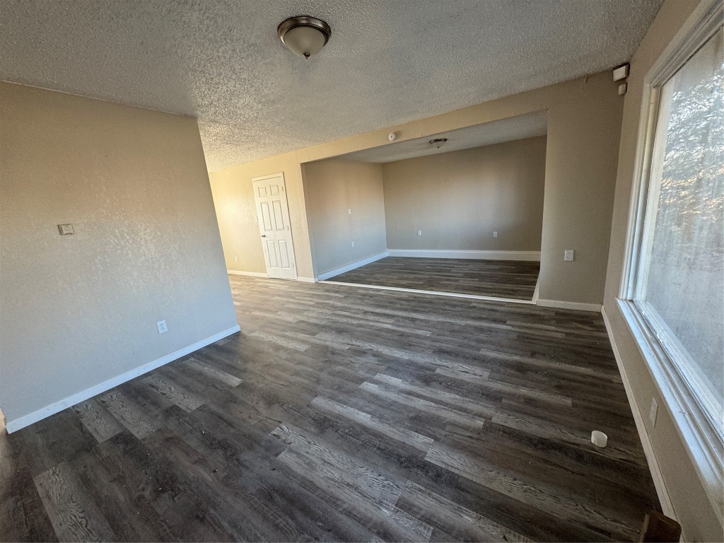 2704 East Colgate Street Lubbock, TX 79403 - Photo 4 of 11 a view of room with window and wooden floor