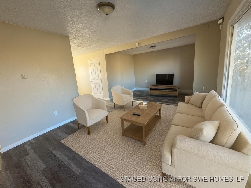 2704 East Colgate Street Lubbock, TX 79403 - Photo 5 of 11 a living room with furniture and a flat screen tv