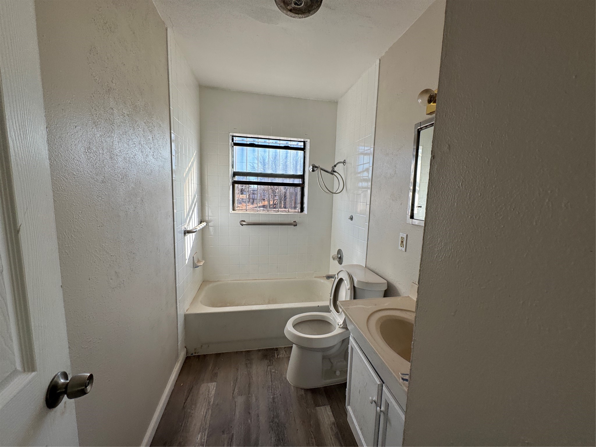 2704 East Colgate Street Lubbock, TX 79403 - Photo 10 of 11 a bathroom with a sink a toilet and shower