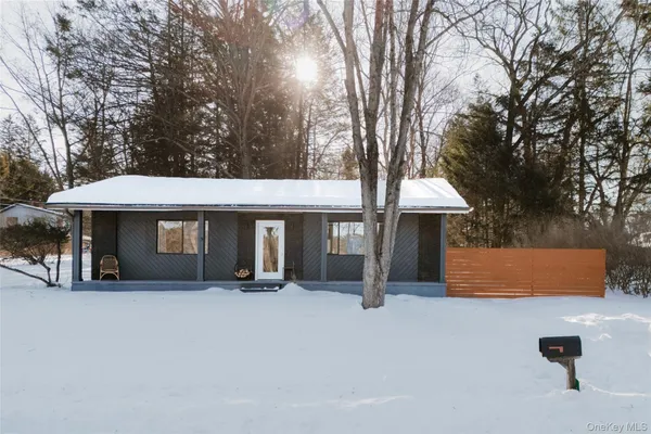 a backyard of a house with barbeque oven and table and chairs