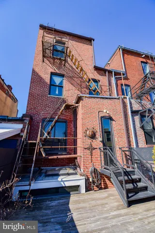a bathroom with a toilet and a painting on the wall