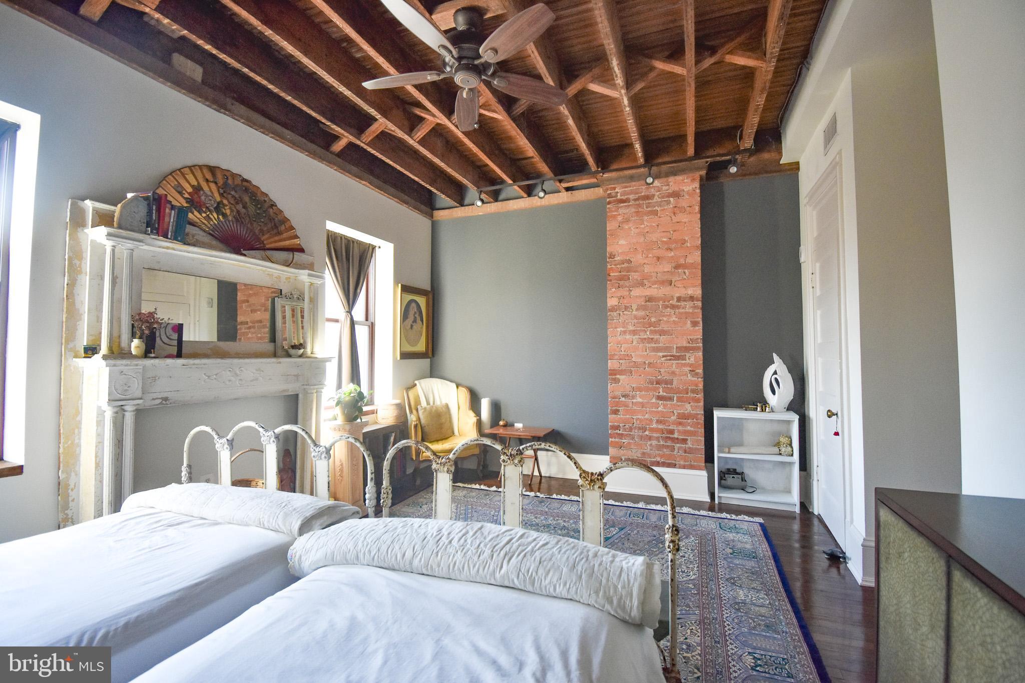 1830 Columbia Road Northwest Washington, DC 20009 - Photo 19 of 46 a bed room with a bed and a table