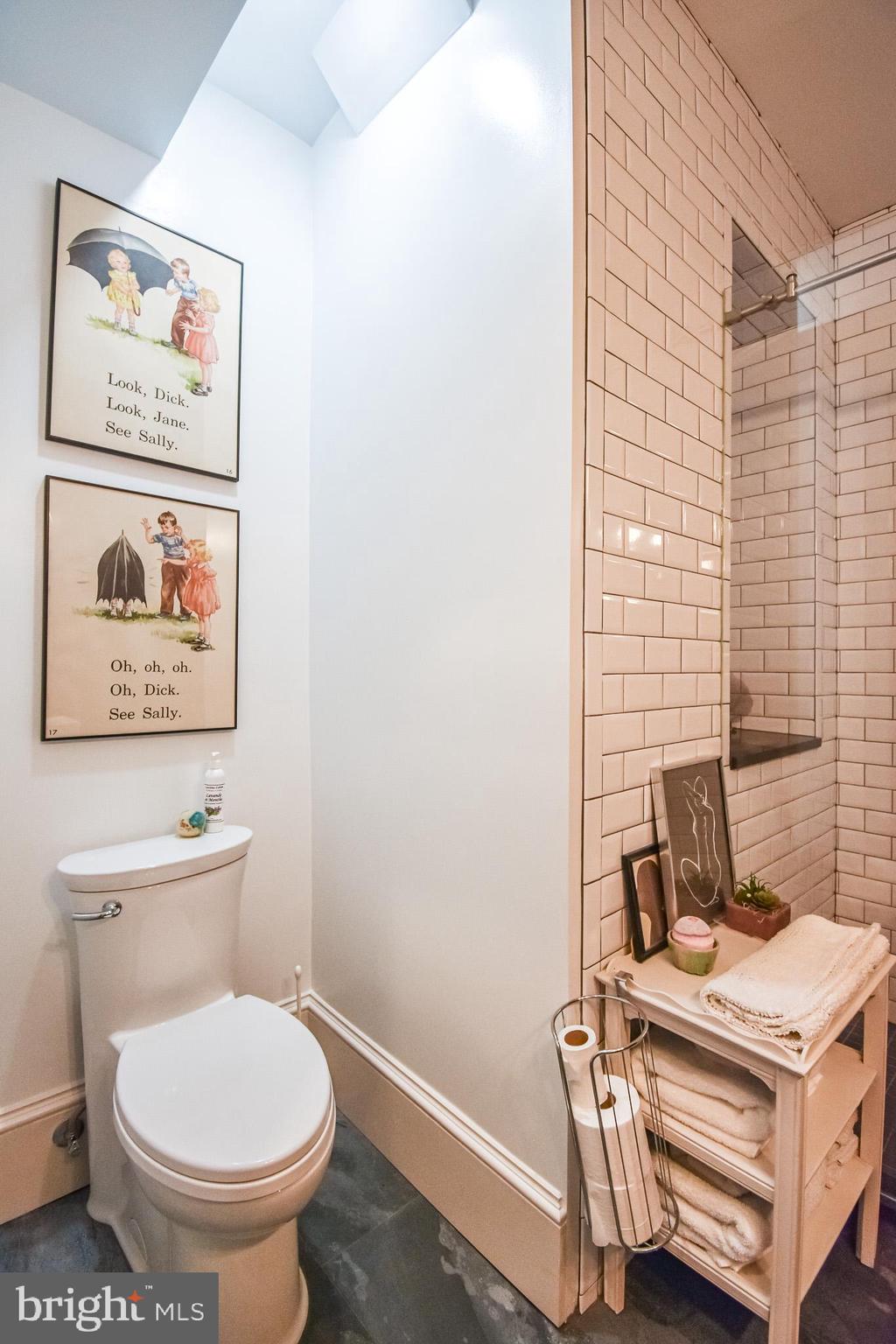 1830 Columbia Road Northwest Washington, DC 20009 - Photo 20 of 46 a bathroom with a toilet and a painting on the wall
